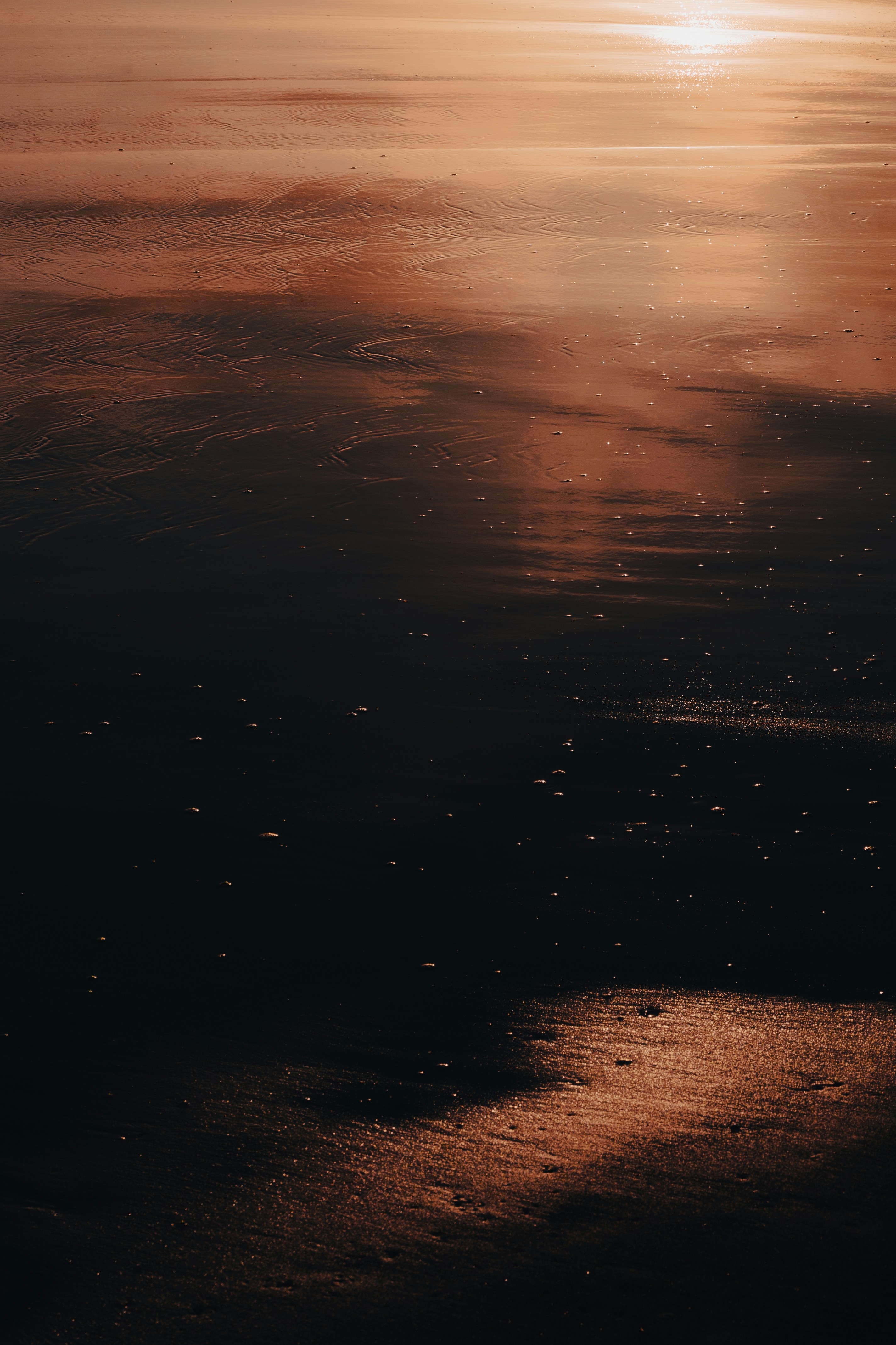 the sun is setting over the water and reflecting on the water