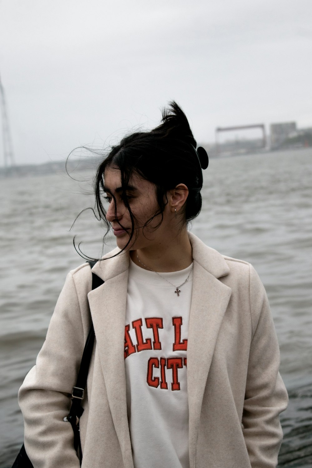 a woman standing in front of a body of water