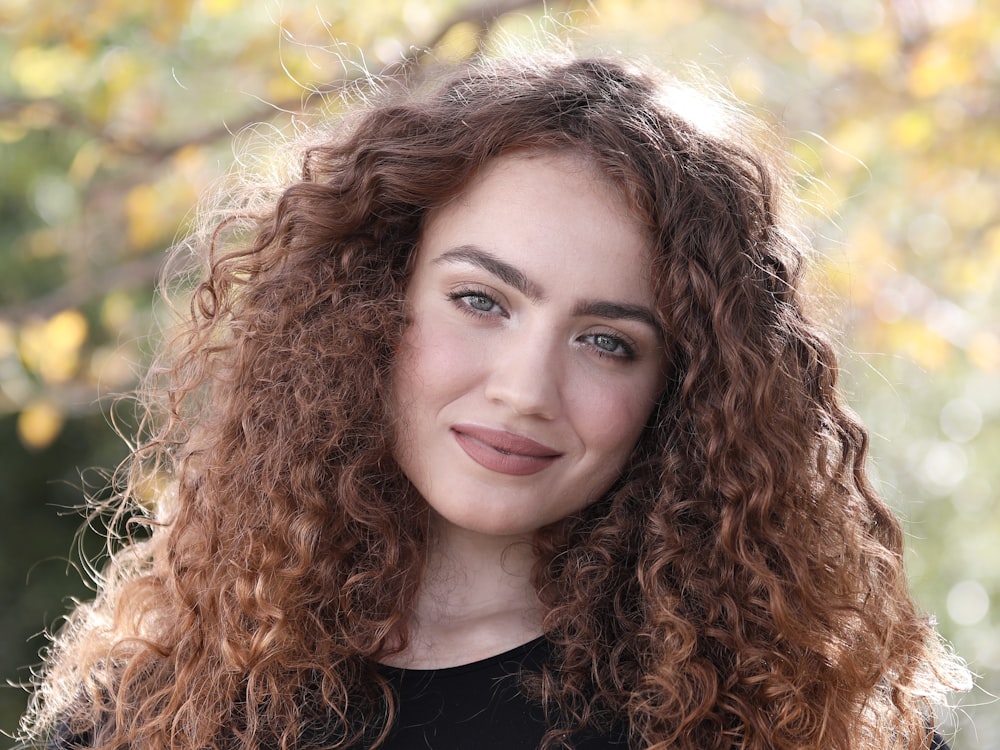 a close up of a person with curly hair