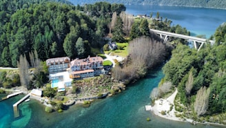 an aerial view of a house and a bridge