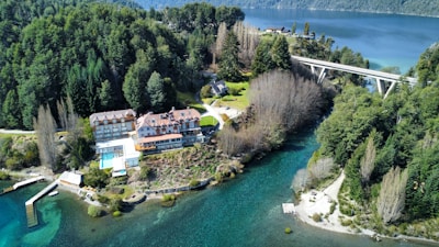 an aerial view of a house and a bridge