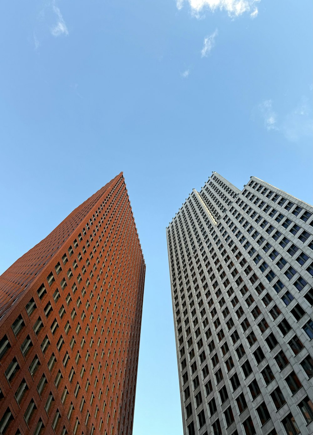 a couple of tall buildings sitting next to each other