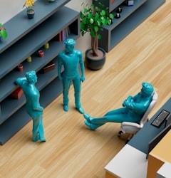 a group of blue statues sitting on top of a wooden floor