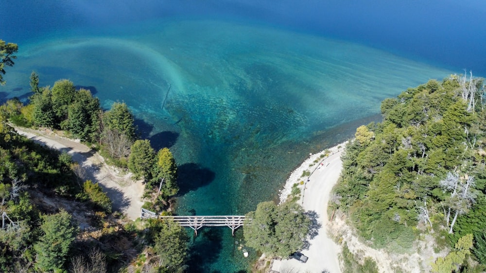 an aerial view of a bridge over a body of water