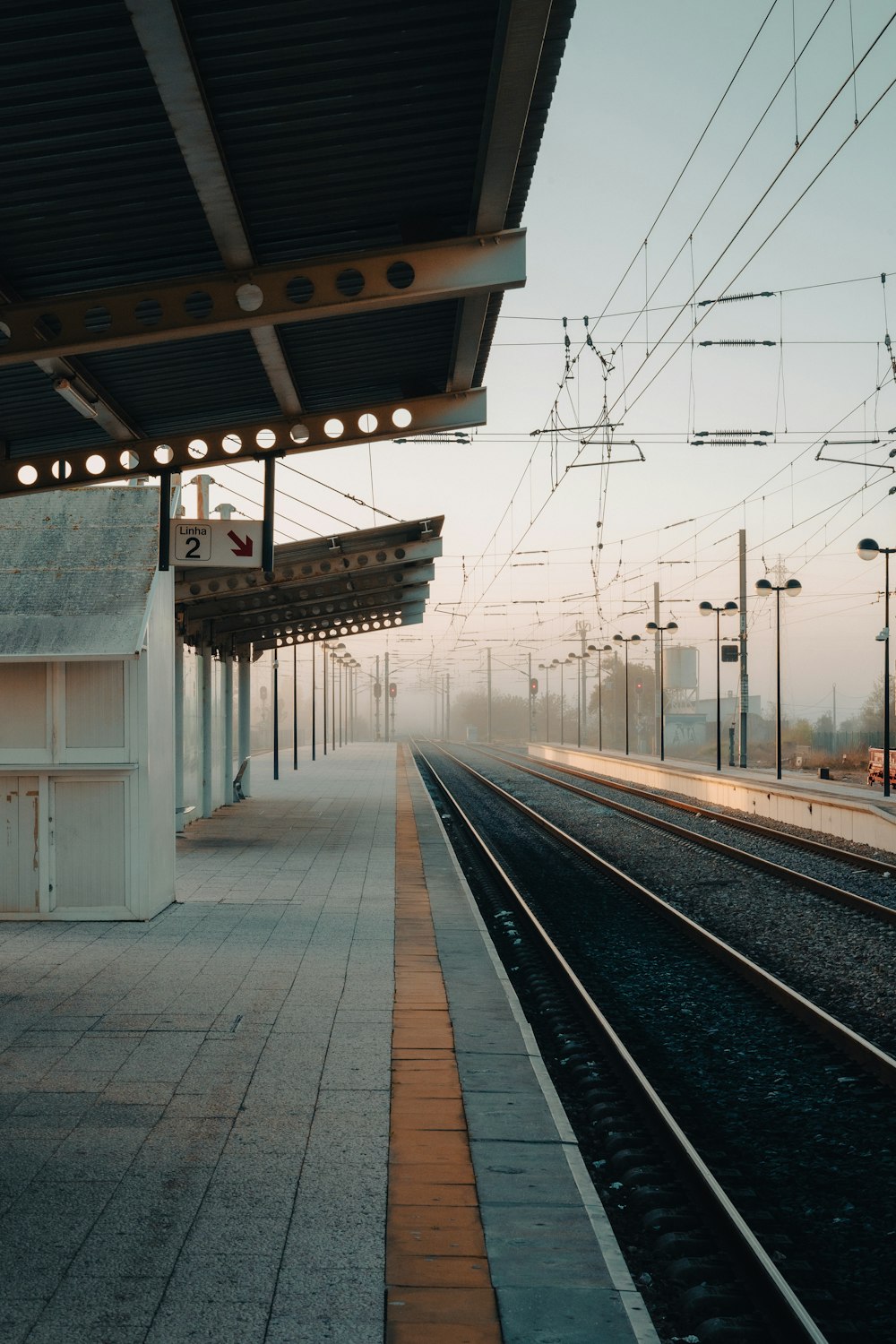 a train station with a train on the tracks