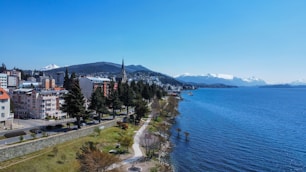 an aerial view of a city next to a body of water
