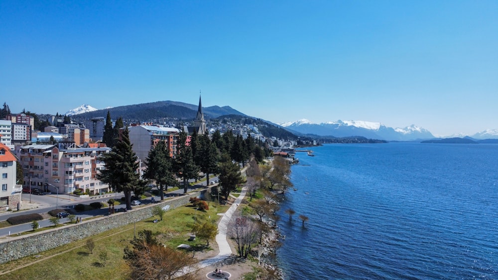 an aerial view of a city next to a body of water