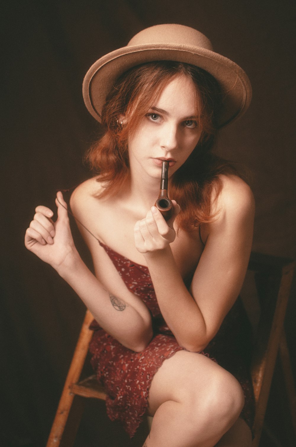 a woman in a hat holding a gun