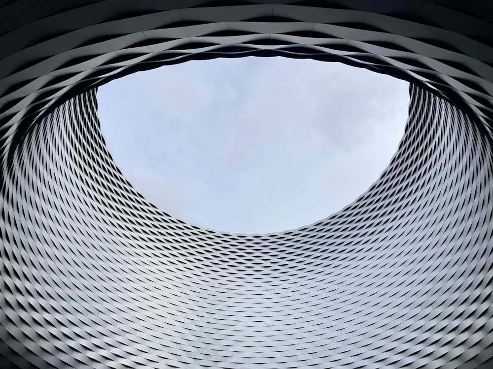 a circular building with a sky in the background