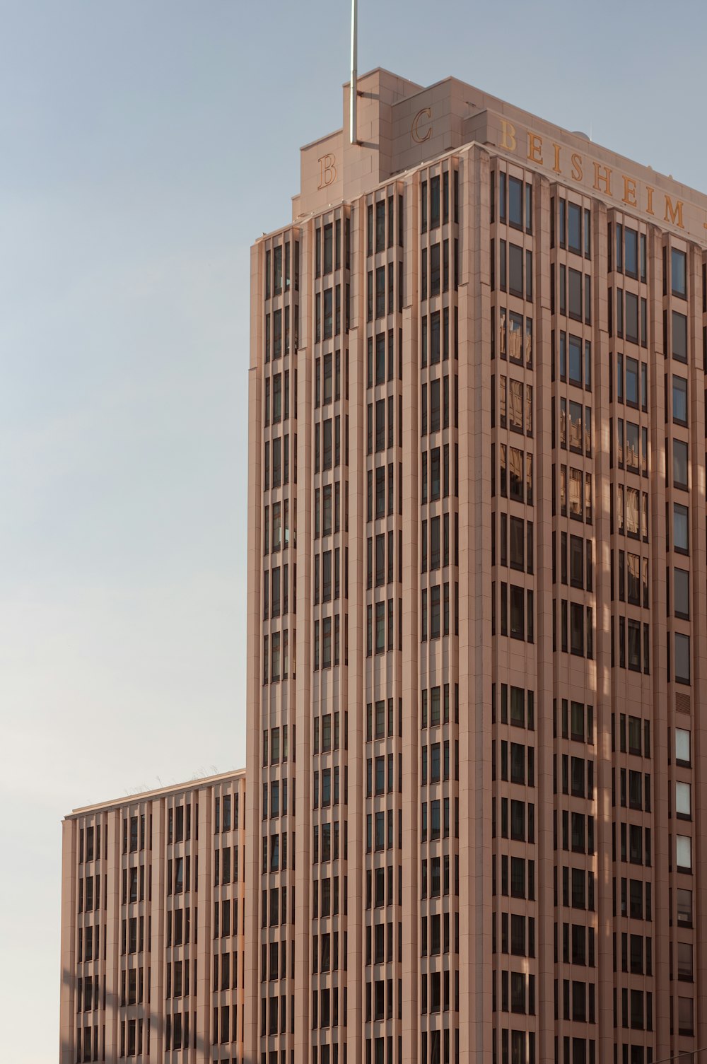 a tall building with a flag on top of it