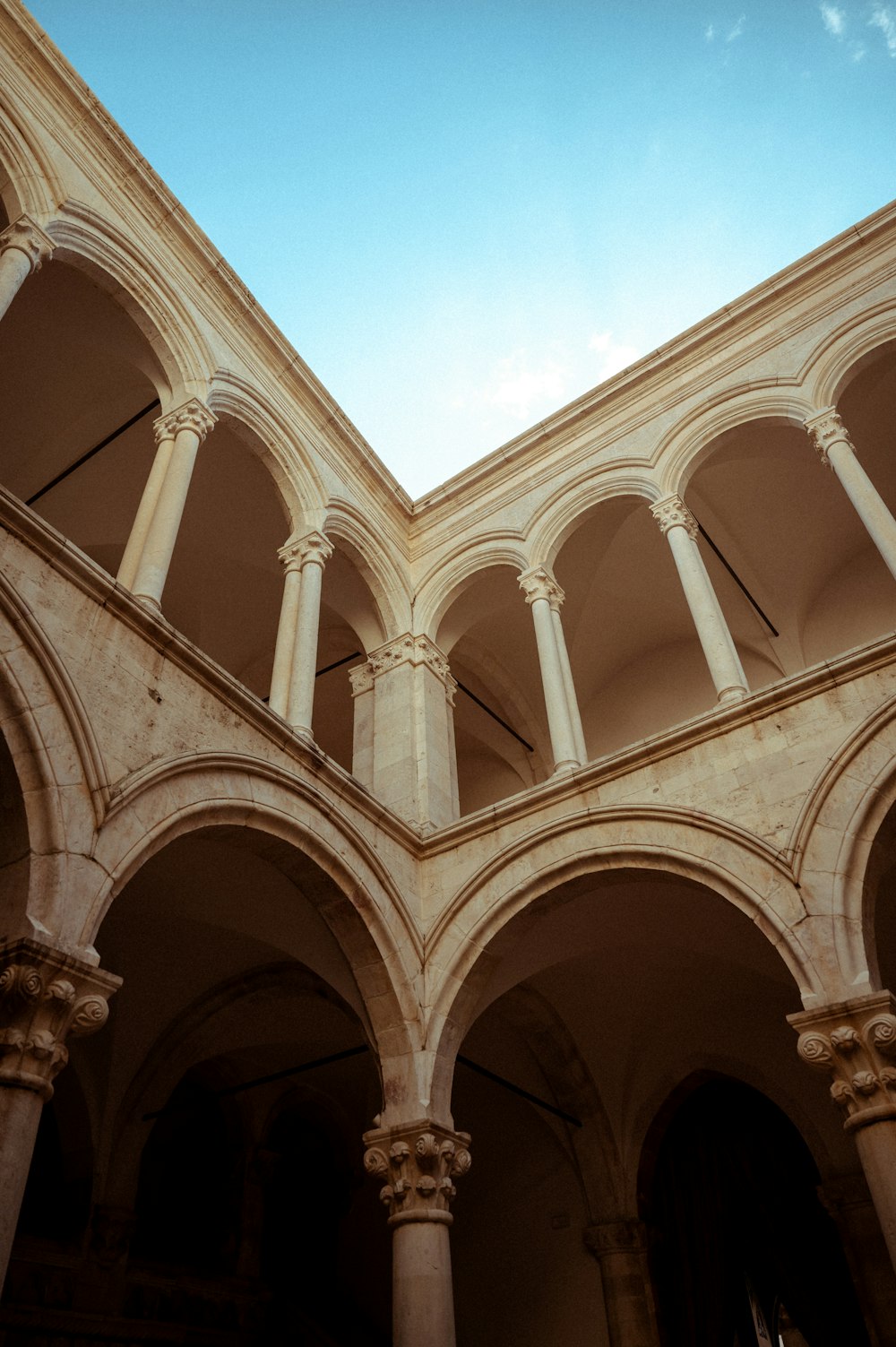 a building with arches and a clock on the wall