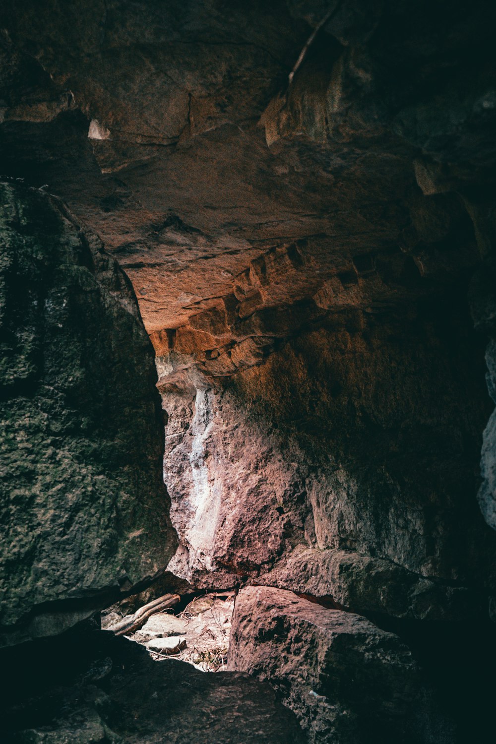 a person standing in a cave on a rock