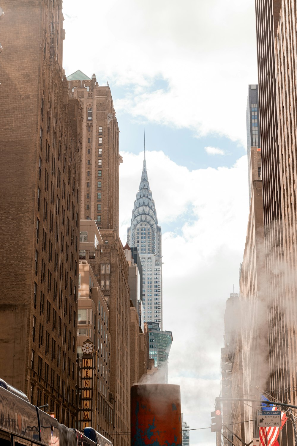 a city street with tall buildings in the background