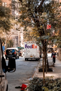 a fed ex truck parked on the side of a street