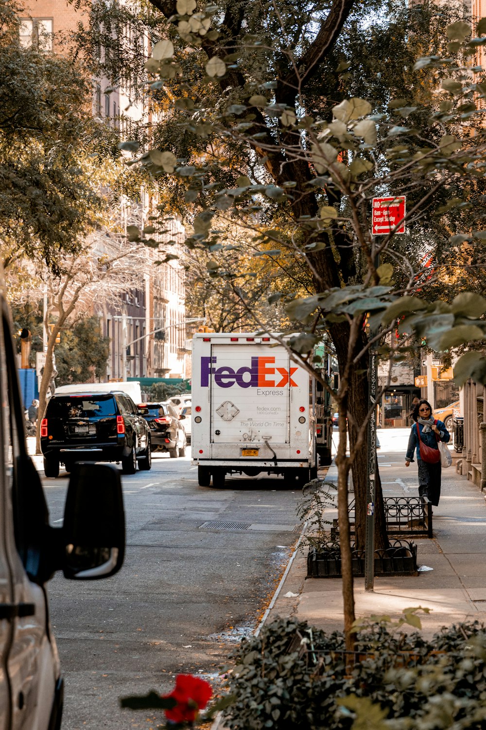 a fed ex truck parked on the side of a street