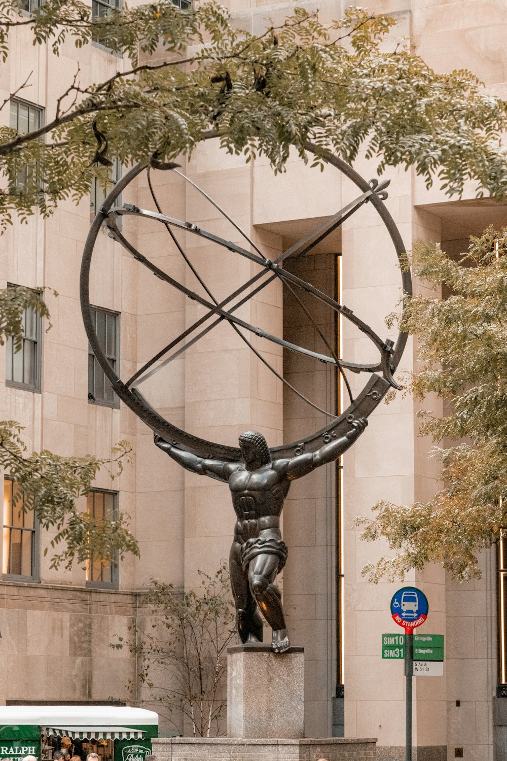a statue of a man holding a large circular object