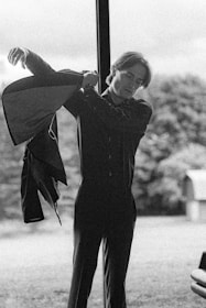 A serene outdoor scene with a model wearing layered outerwear, capturing effortless modern style.