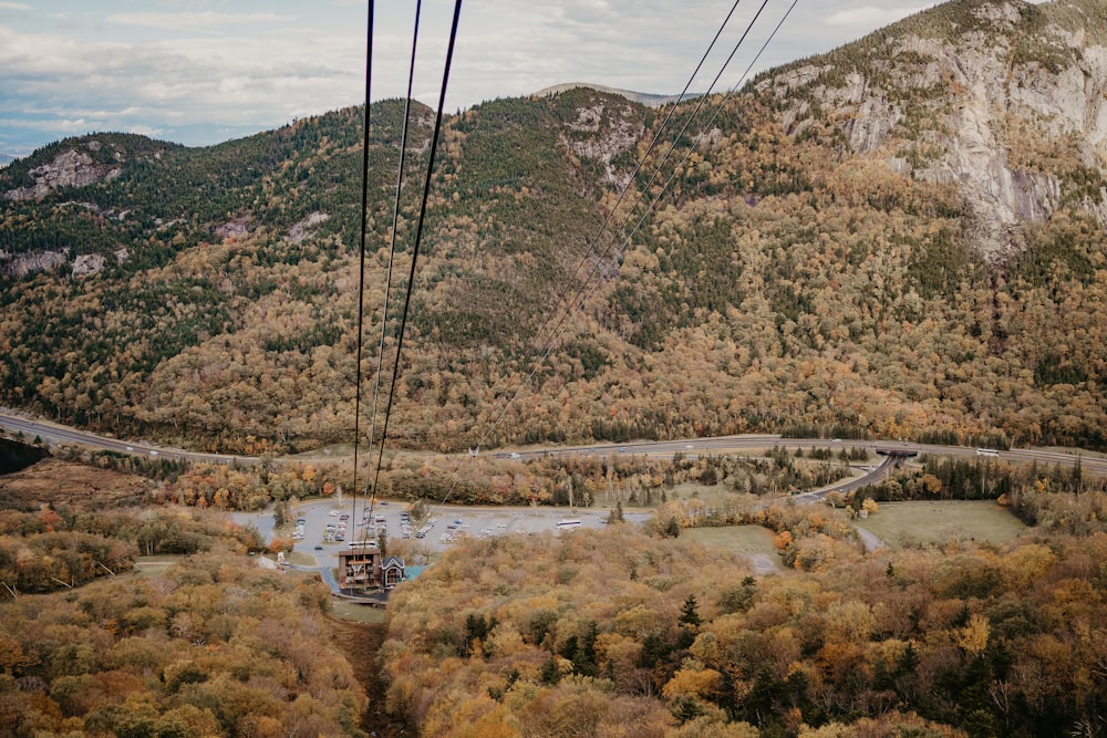 a cable car going over a river in the mountains