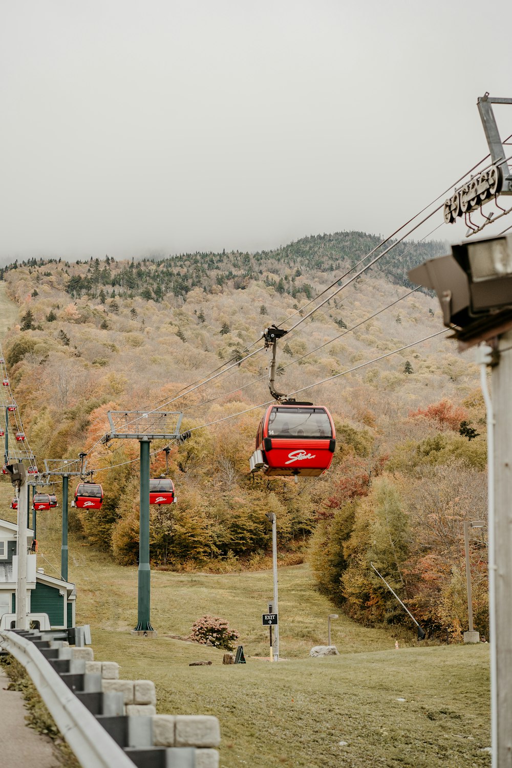 a red cable car going up a hill