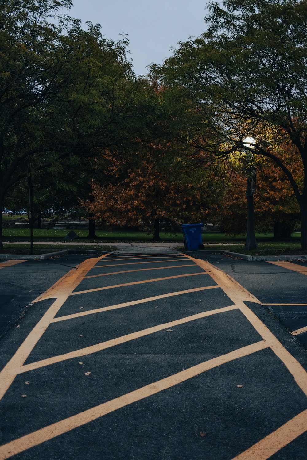 a parking lot with a trash can in the middle of it