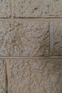Close-up of a wall with a textured paint finish in warm earthy tones.