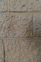 Close-up of a richly textured wall finish in warm earthy tones, highlighting artisanal craftsmanship.