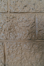 Close-up of a wall with a textured decorative paint effect in warm earth tones.