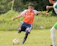 A young soccer player proudly wearing a West Texas Strikers jersey, mid-game action.