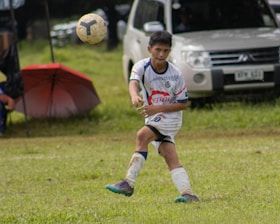 Young soccer player being analyzed by AI technology on a digital screen.