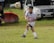 A young athlete practicing soccer on a sunny field, showcasing determination and focus.
