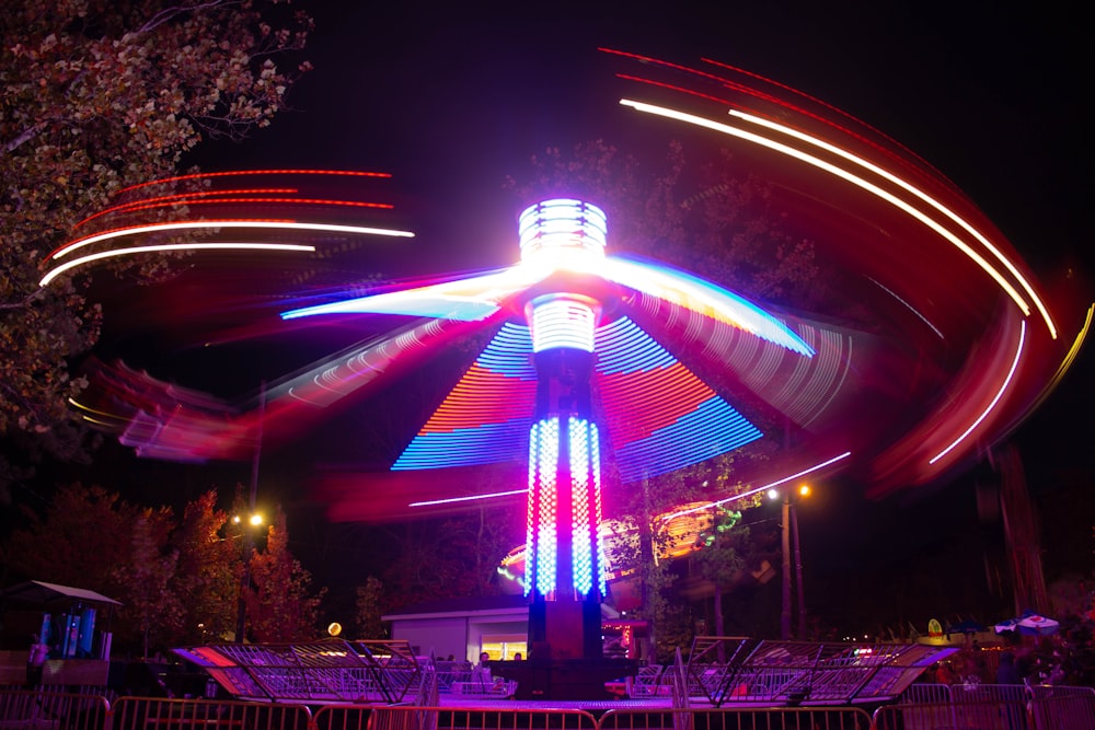 a carousel at night lit up with colorful lights