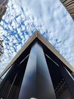 An aerial shot of a modern building complex with sharp angles and reflective glass surfaces.