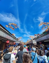 Family walking through a vibrant autumn market in a quaint Spanish village.