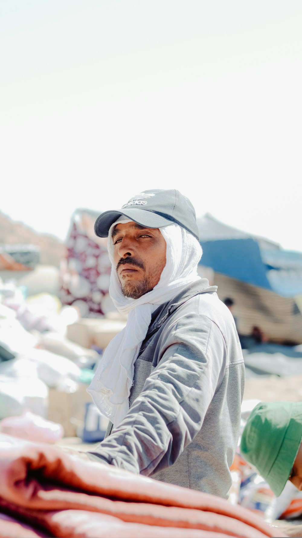 a man standing next to a pile of sand