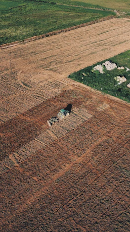 an aerial view of a field with a tractor in the middle of it