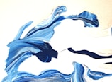 Abstract art representing flowing air currents in soft blues and whites.