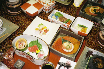 Traditional Japanese multi-dish meal spread across small ceramic bowls on a table