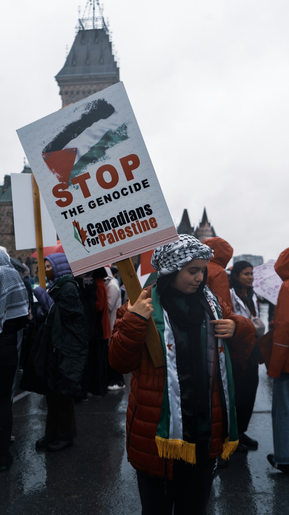 a woman holding a sign at a protest