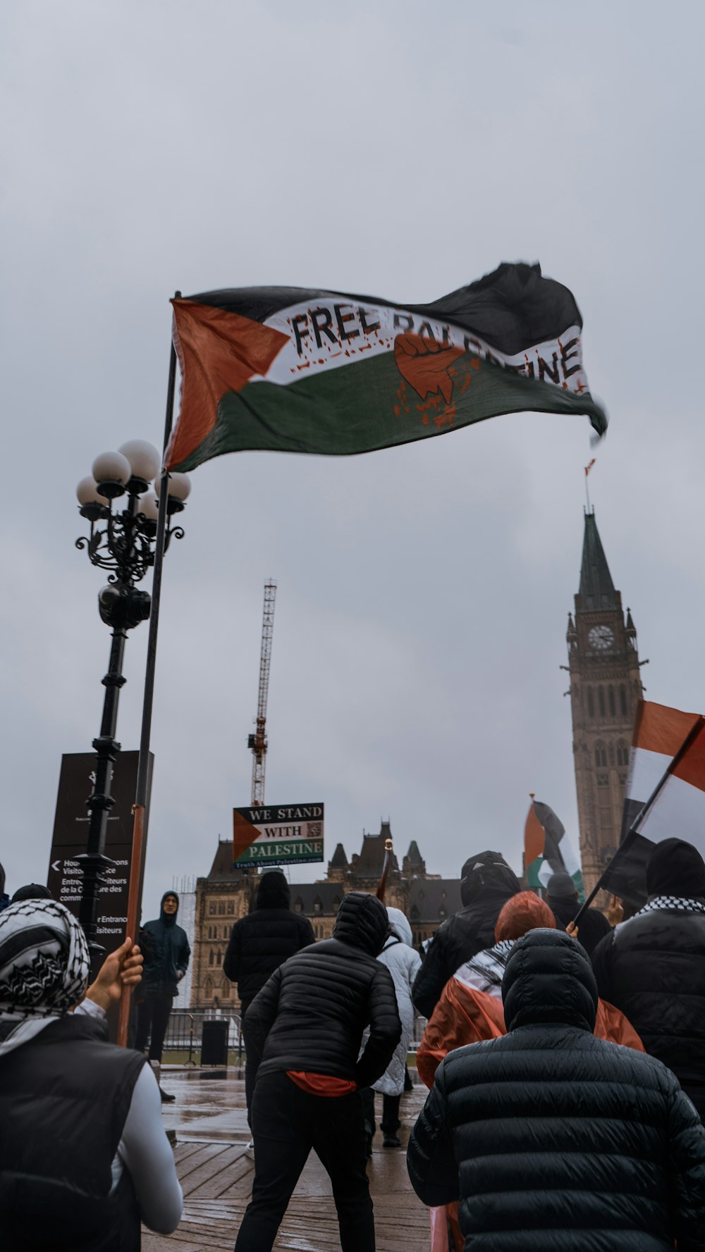 a group of people standing around a flag