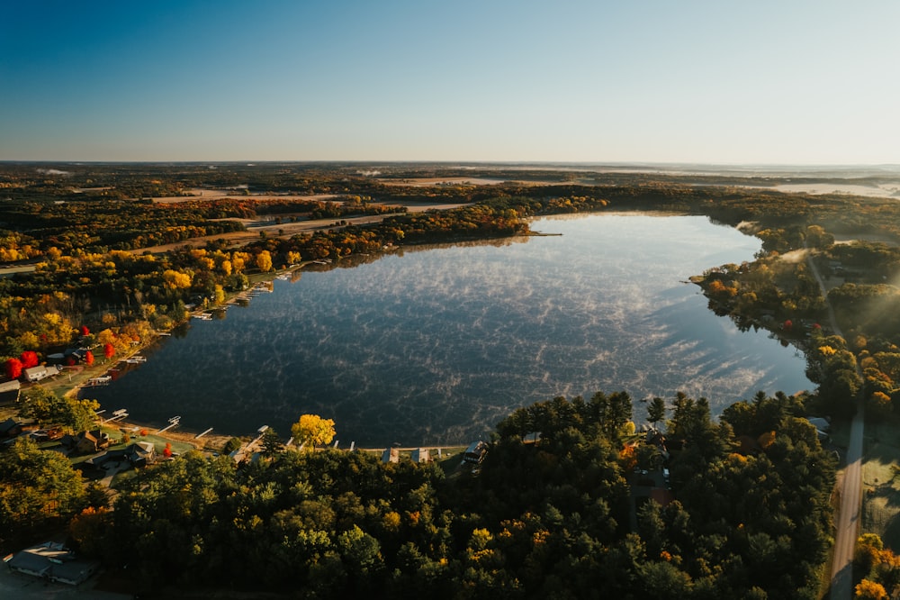 an aerial view of a lake surrounded by trees