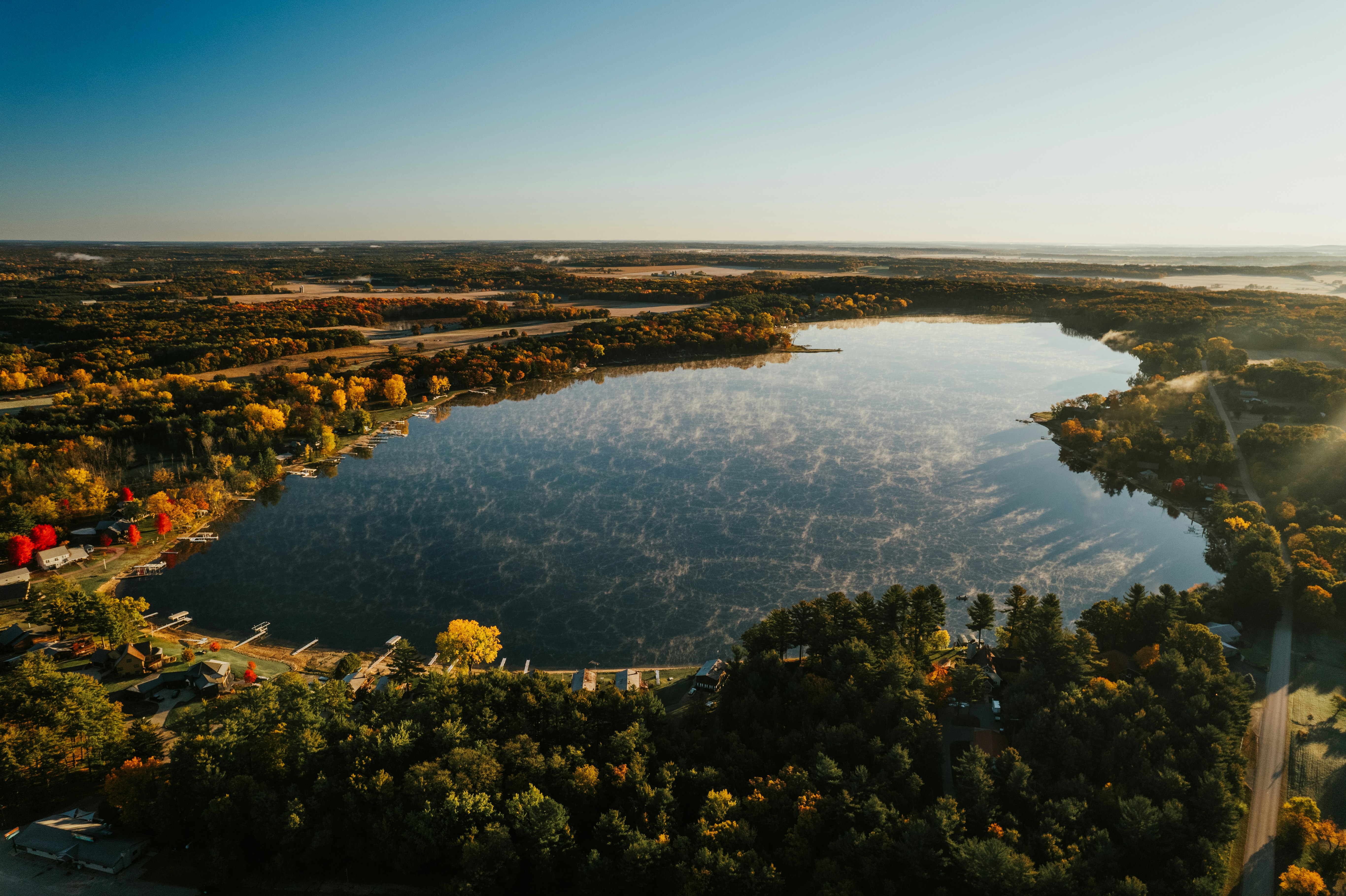 an aerial view of a lake surrounded by trees