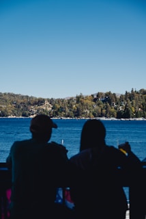 A couple enjoying morning coffee on the porch overlooking Callender Lake.