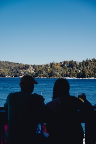 A couple enjoying morning coffee on the porch overlooking Callender Lake.