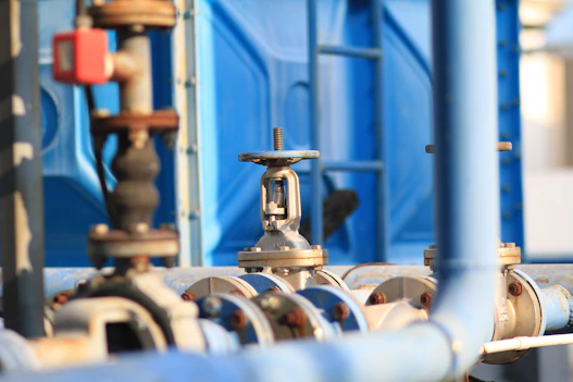 a close up of pipes and valves in a factory