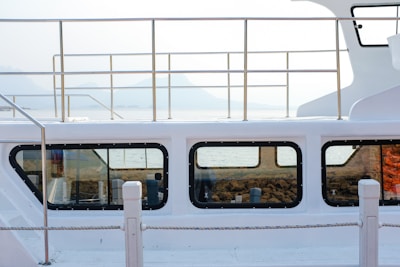 Marine boat with freshly applied window tint reflecting the calm water surface.