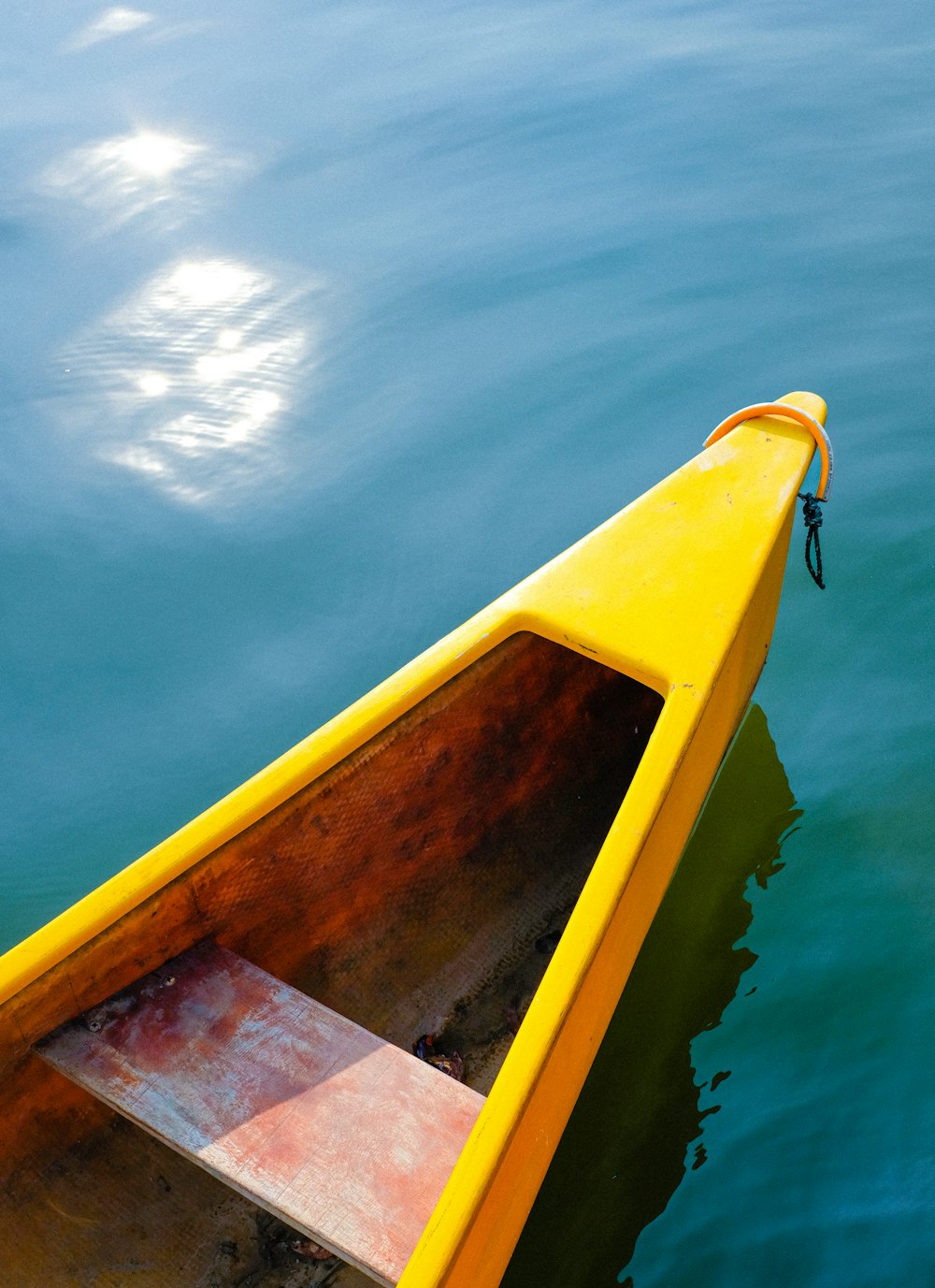 a yellow boat floating on top of a body of water