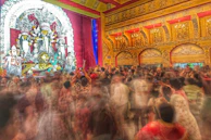 A panoramic shot of a bustling event hall filled with vibrant cultural decorations.