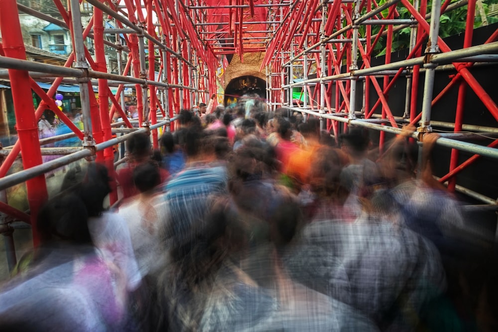 a group of people walking down a red bridge