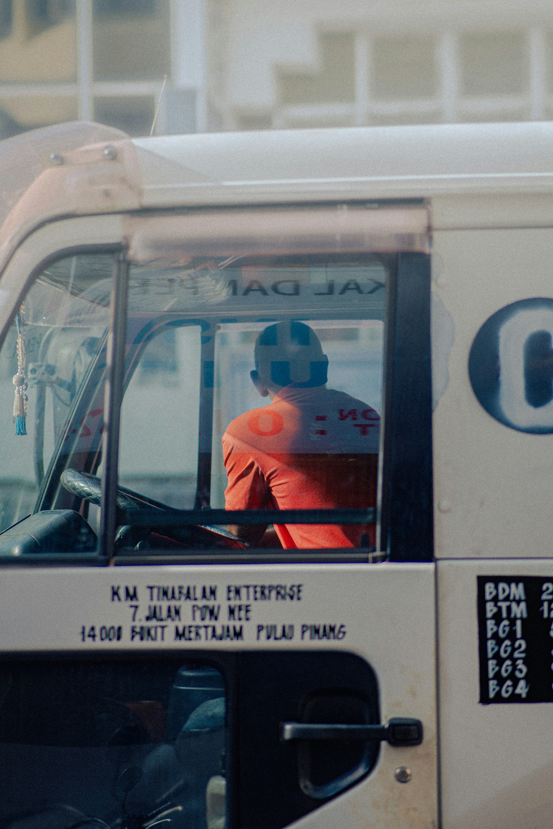 a man sitting in the driver's seat of a truck