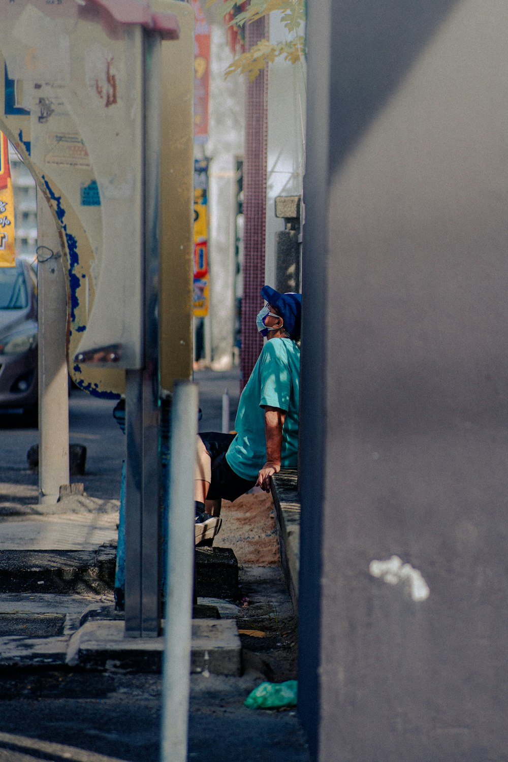 a person sitting on a bench on a city street